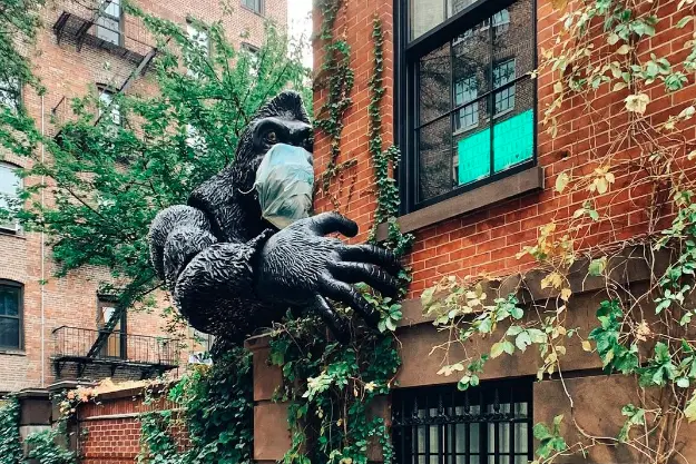 a sculpture of a gorilla hugging a building